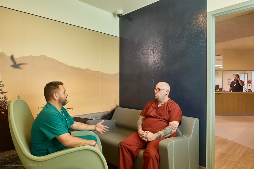 Photo of two staff members talking in a Connections Health facility