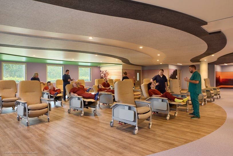 Image of staff members interacting with patients in a common area at a Connections Health facility